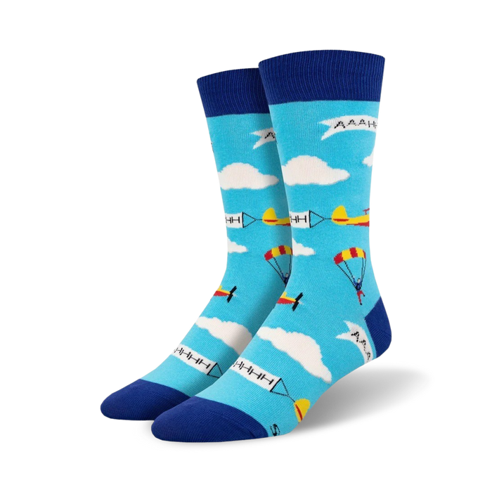mens skydiver crew socks with light blue background, white clouds, four skydivers with colored parachutes, and two airplanes.  