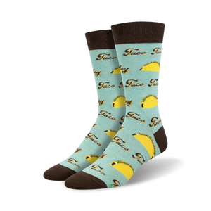 Pair of crew socks; light teal, brown cuffs; all-over print of yellow tacos and 'Taco Tuesday' text.