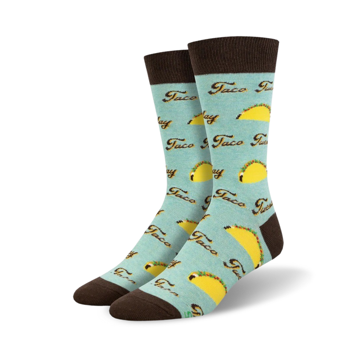 Pair of crew socks; light teal, brown cuffs; all-over print of yellow tacos and 'Taco Tuesday' text.
