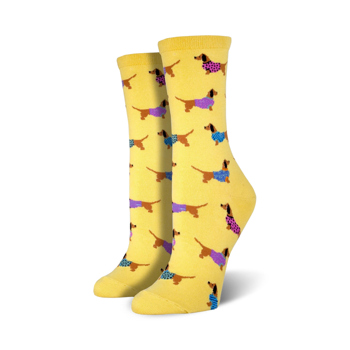 Lifestyle shot of the yellow Haute Dog socks on a model's feet.