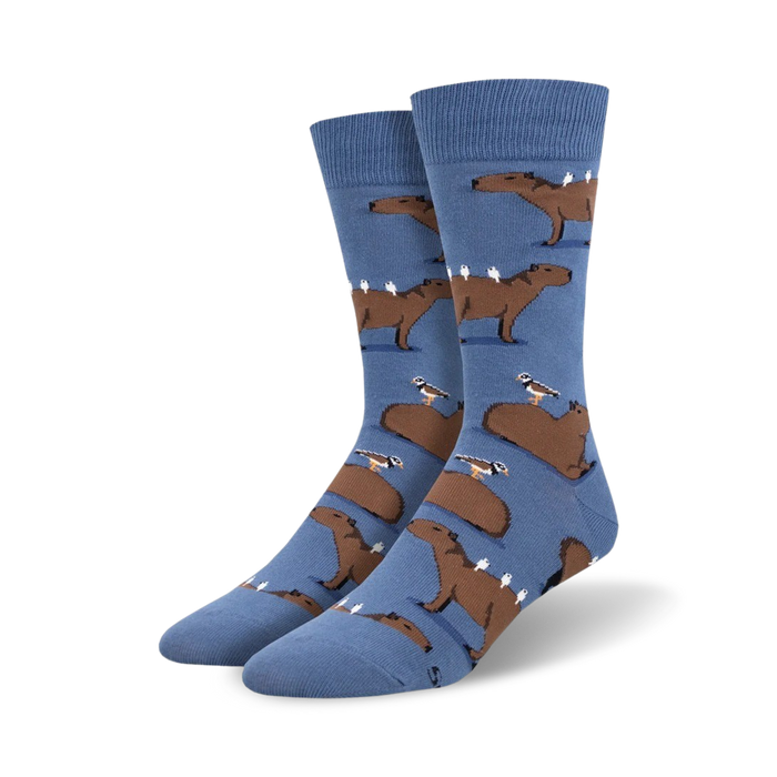 Crew socks in blue featuring brown capybaras and small birds. Fun, quirky design for a touch of whimsy! }}