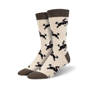 Pair of cream crew socks with a repeating pattern of black dogs riding horses. Brown cuff.