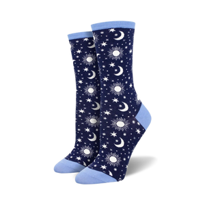 Pair of navy blue crew socks with a pattern of white moons, suns, and stars. Light blue cuffs.