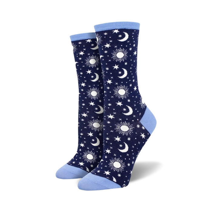 Pair of navy blue crew socks with a pattern of white moons, suns, and stars. Light blue cuffs.