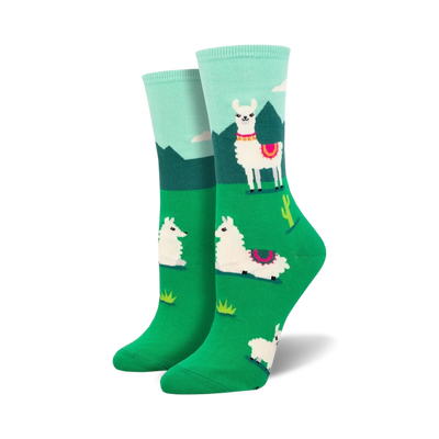 A pair of women's crew socks in teal, green, and white. The socks feature a fun design of llamas in a grassy landscape with cacti.