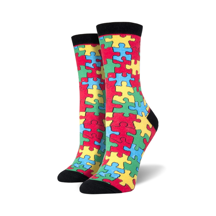 Pair of women's crew socks with a colorful puzzle piece design. The main colors are red, yellow, blue, and green. }}