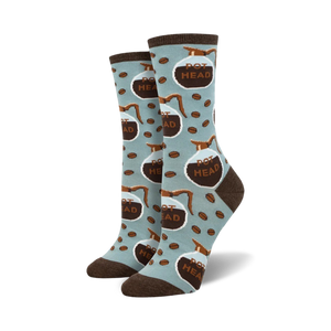 Lifestyle shot of 'Pot Head' socks on a model's feet; light blue socks with brown coffee pot design.