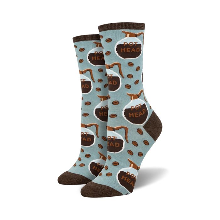 Lifestyle shot of 'Pot Head' socks on a model's feet; light blue socks with brown coffee pot design.
