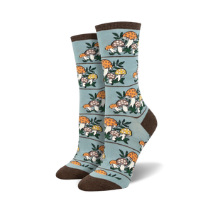 Pair of crew socks, teal and brown, with a repeating pattern of illustrated mushrooms and leaves.