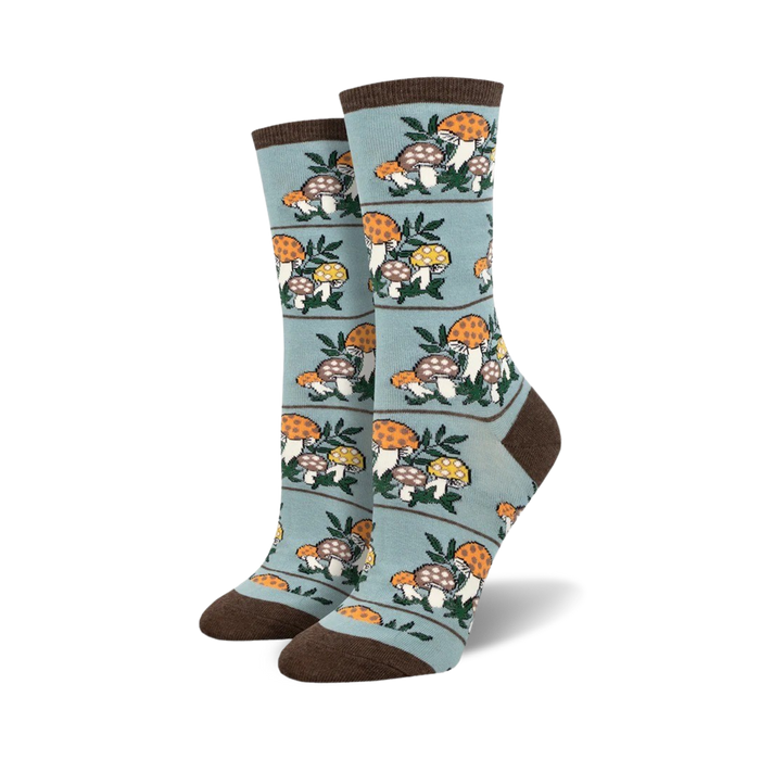 Pair of crew socks, teal and brown, with a repeating pattern of illustrated mushrooms and leaves.