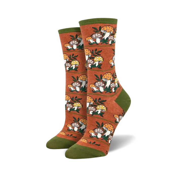 Lifestyle photo showing the orange Magic Mountain socks on a person's feet, suggesting outdoor or nature-related activities.