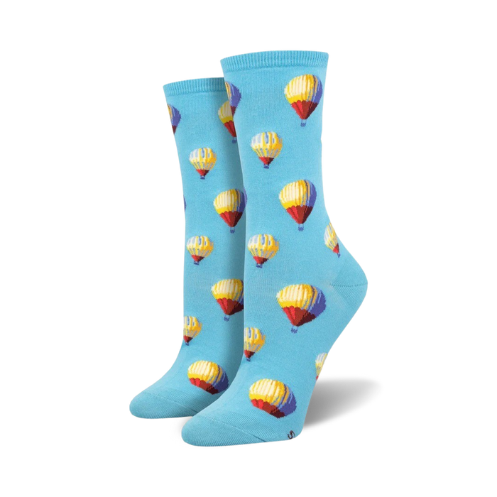 A pair of women's crew socks in light blue with a repeating pattern of multicolored hot air balloons. }}