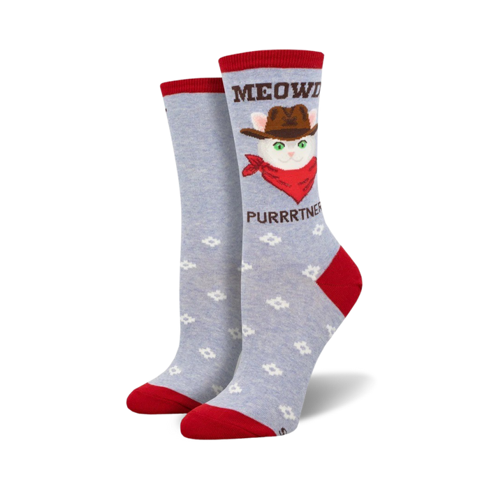 Crew socks in light blue with a repeating flower pattern. Feature a cowboy cat graphic with the text 'MEOWDY PURRRRTNER'. Red accents on cuff and heel. }}