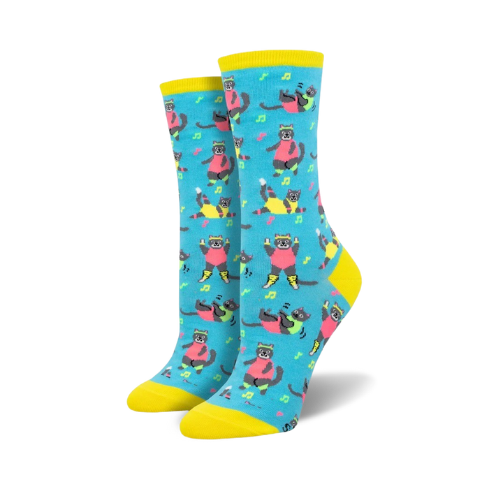 Pair of women's crew socks in teal, featuring a pattern of grey cats in bright pink and neon yellow Jazzercise outfits. Musical notes are scattered throughout. }}