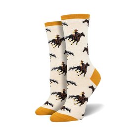 white crew socks with a yellow top, brown heel and toe featuring a cowboy on a galloping horse.   