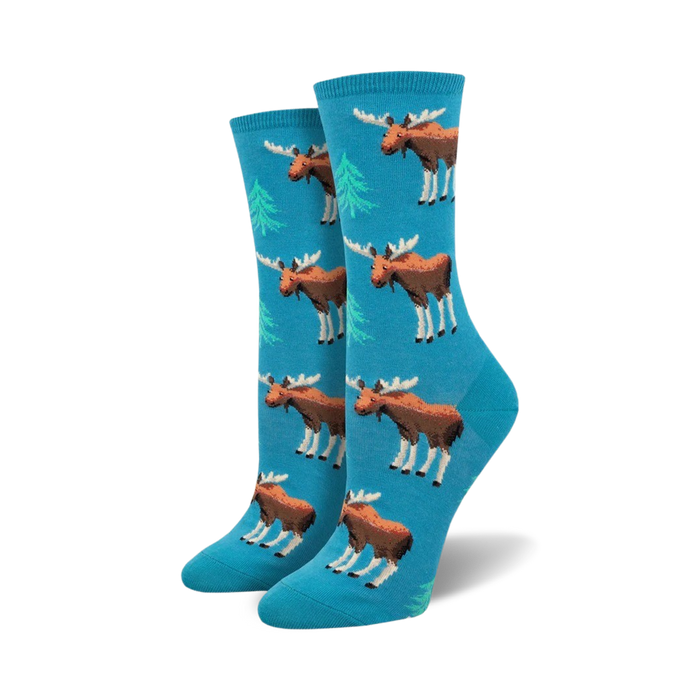 A pair of women's crew socks in teal blue. The socks are adorned with a repeating pattern of brown moose and light green spruce trees. }}
