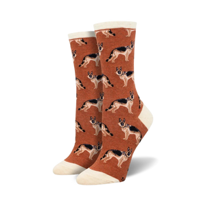 A pair of rust-colored crew socks with a repeating German Shepherd pattern. The socks have a cream-colored cuff.