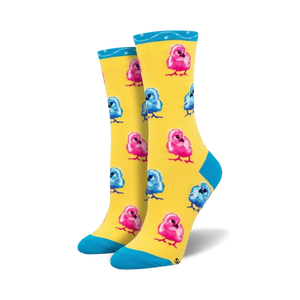 Pair of crew socks featuring a pattern of pink and blue chicks on a yellow background. Teal cuff detail.