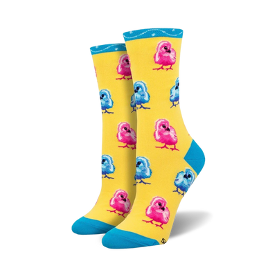 Pair of crew socks featuring a pattern of pink and blue chicks on a yellow background. Teal cuff detail.