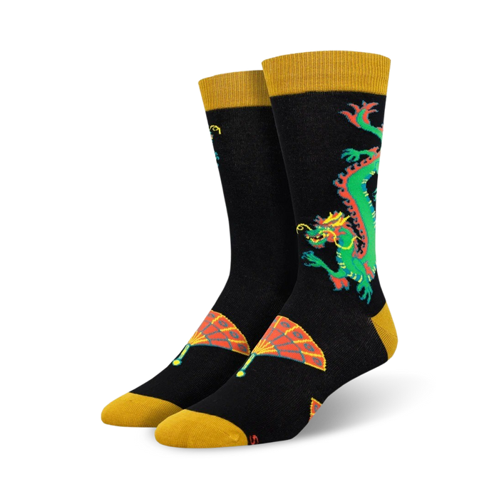 Close-up of black crew socks with a gold cuff, showcasing a detailed dragon and fan design.