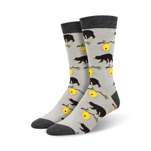 Pair of crew socks in grey and featuring black bears and yellow honeycombs on a light grey background.