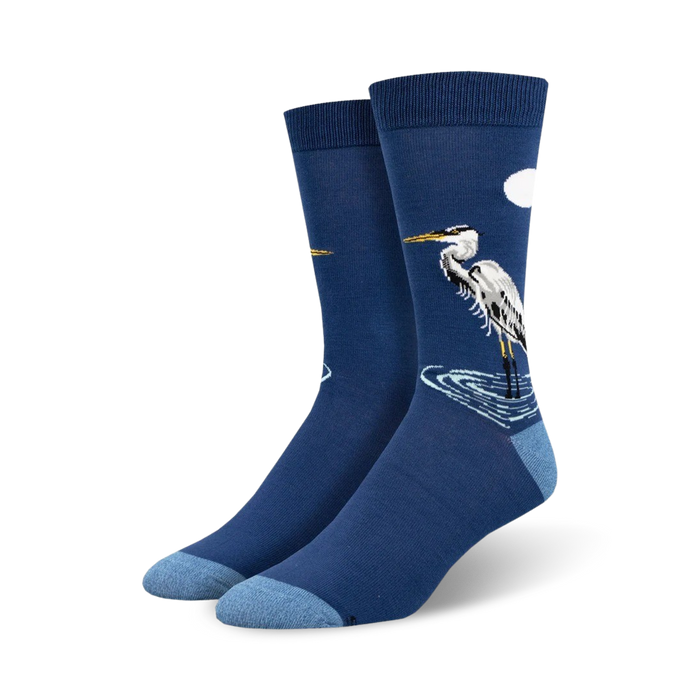 dark blue crew socks for men featuring a pattern of a graceful egret standing in shimmering light blue waters under a golden crescent moon.   }}