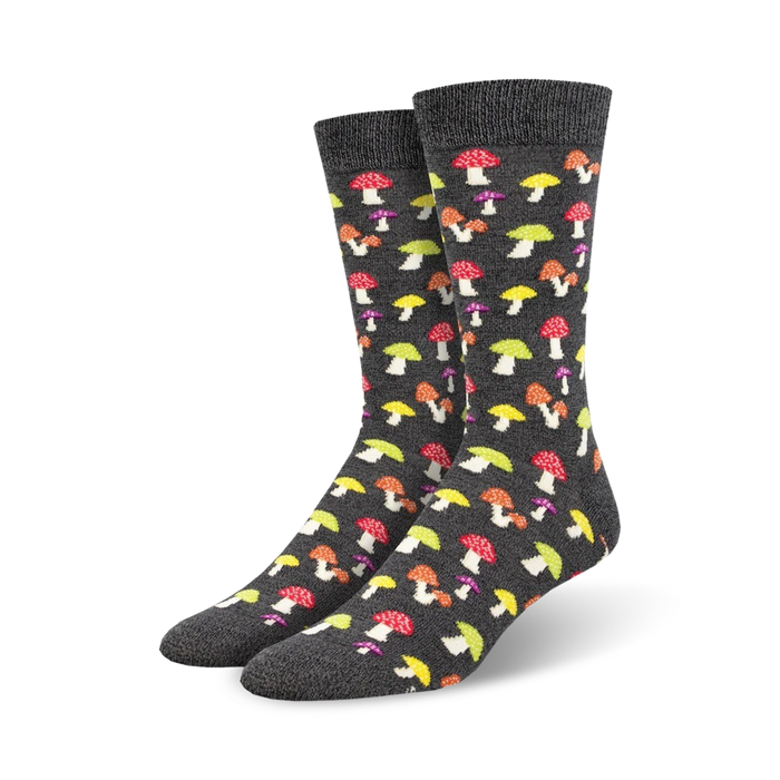 A pair of charcoal grey crew socks adorned with a colorful mushroom pattern. The mushrooms are in shades of red, yellow, and purple. }}