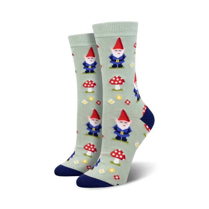 Pair of crew socks, sage green, featuring gnomes, mushrooms, and flowers.