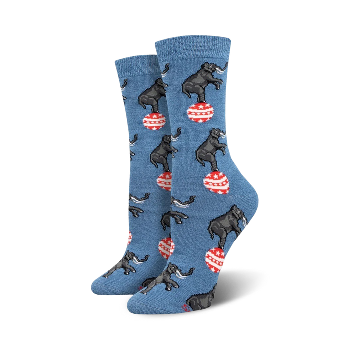 A pair of women's crew socks in blue featuring a pattern of elephants balancing on red and white striped balls. }}