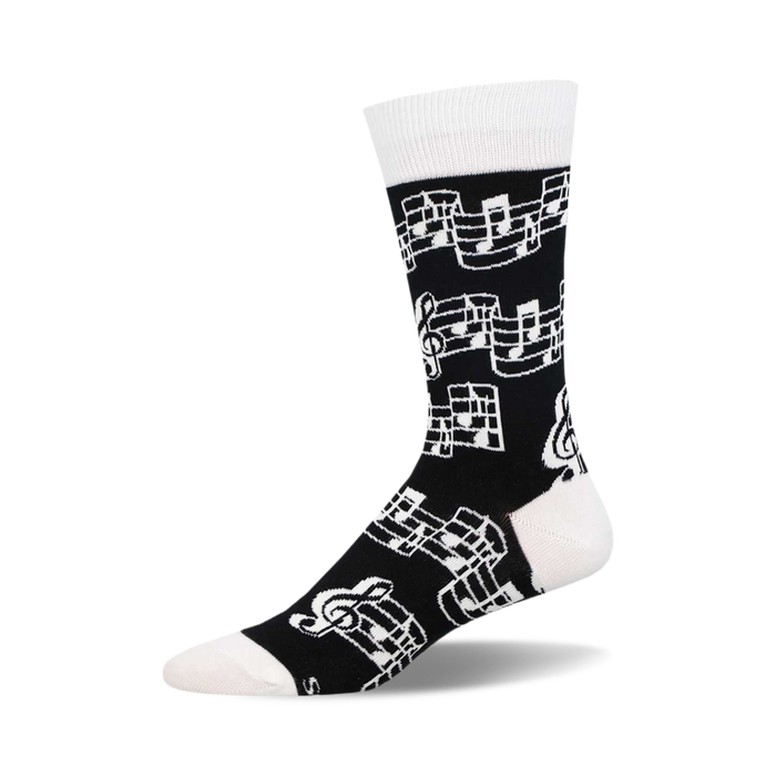 Single crew sock with black background and white musical note and treble clef pattern, white cuff, heel, and toe. }}