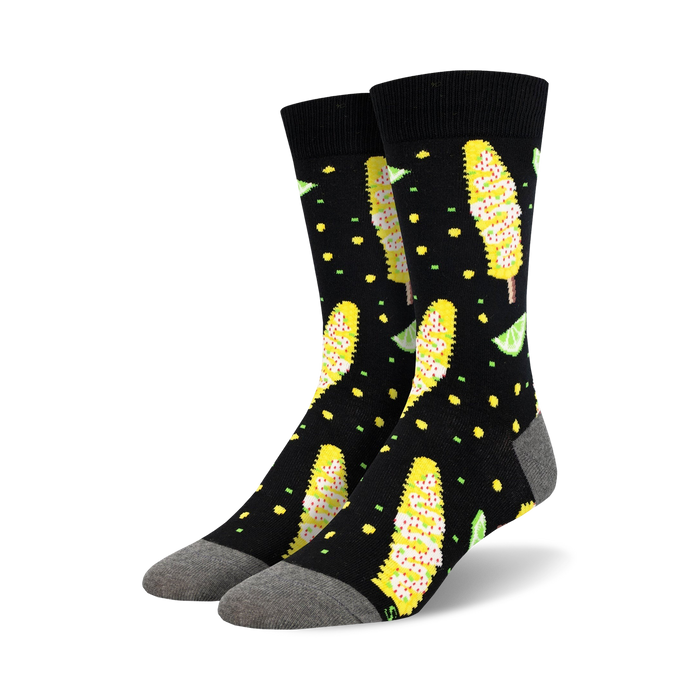 Pair of black crew socks with a fun design of yellow Elote (Mexican street corn) and lime wedges. }}