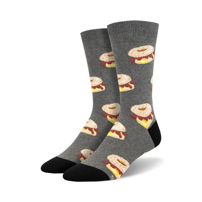 Pair of crew socks in gray with a repeating pattern of illustrated bagels with cream cheese and lox. }}