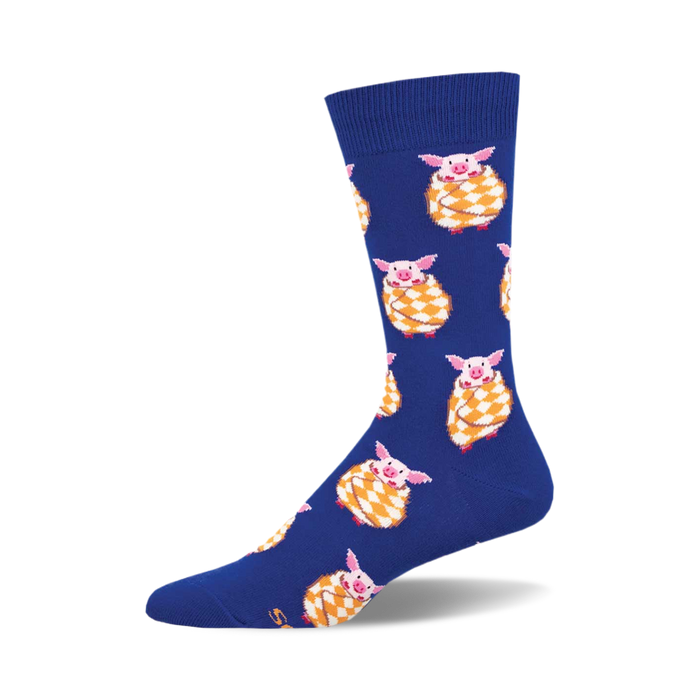 Crew socks in royal blue featuring a pattern of pink pigs wrapped in yellow and orange blankets. }}