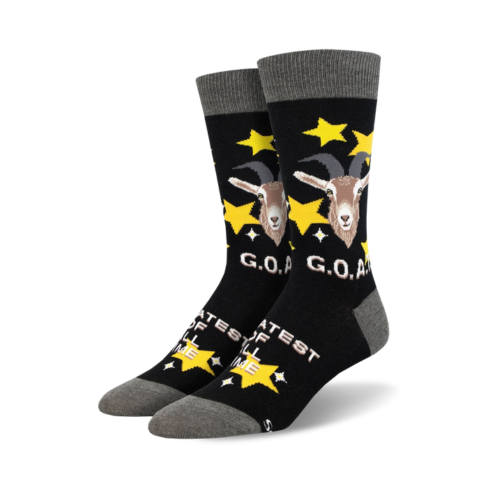 A pair of black crew socks with a goat design, gold stars, and 'G.O.A.T.' text. The socks have a grey cuff. }}