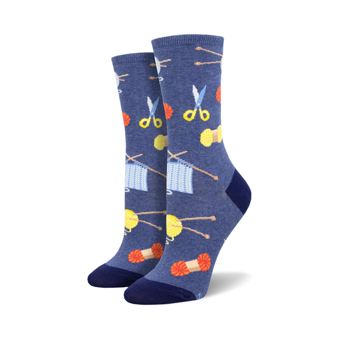 A pair of women's crew socks in blue featuring knitting needles, yarn, and scissors. The design is colorful and fun! }}