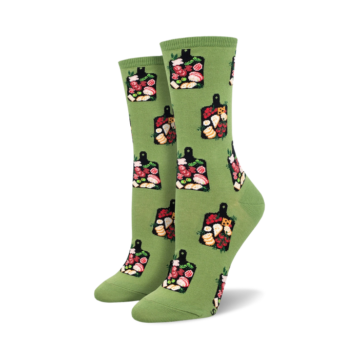 Pair of women's crew socks in green and teal, featuring a repeating pattern of charcuterie boards with cheeses, meats, and fruits.