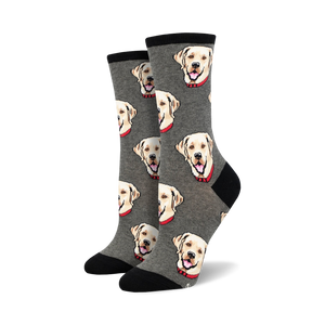 Pair of crew socks with a repeating pattern of yellow Labrador Retriever faces on a grey background.  Black cuffs.