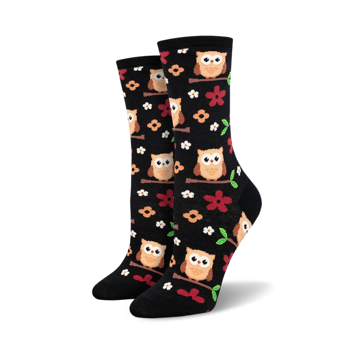 Pair of women's crew socks. Black background with adorable owls and flowers. Brown, orange, and red accents.
