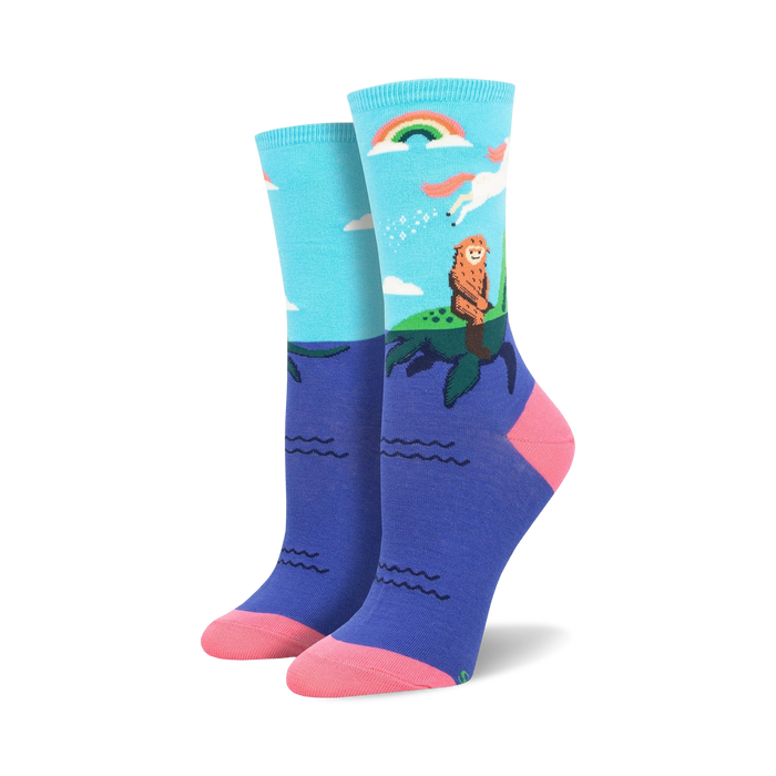 Women's crew socks in teal and purple featuring a Bigfoot watching a unicorn over a rainbow and ocean waves. }}
