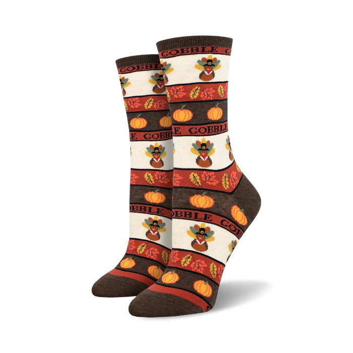 thanksgiving-themed socks with pumpkins, cornucopias, leaves, and turkeys on a white background with brown stripes. made for women in crew length.   }}