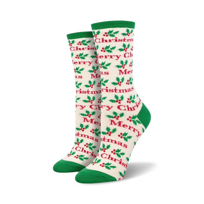 Close-up view of a pair of cream and green 'Merry Christmas' socks.