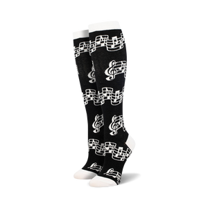 Close-up of black knee-high socks with musical notes pattern.