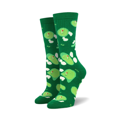Pair of green crew socks with a whimsical putting green and flag design.