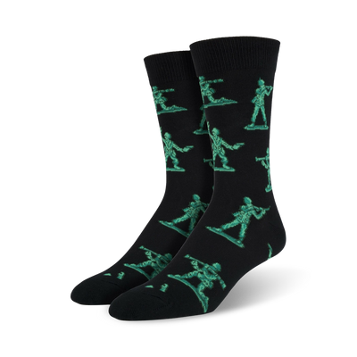 Pair of black crew socks featuring a repeating pattern of teal pixelated army men. Fun and playful design.