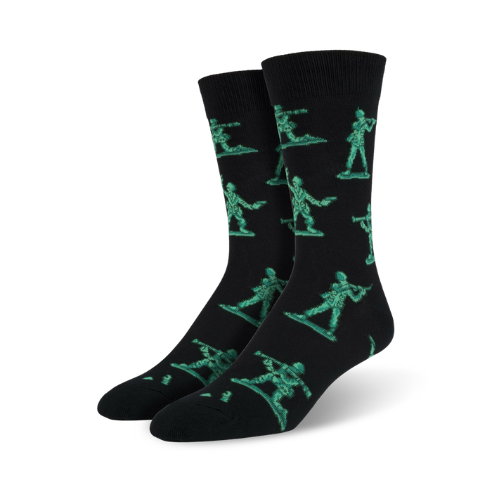 Pair of black crew socks featuring a repeating pattern of teal pixelated army men. Fun and playful design. }}