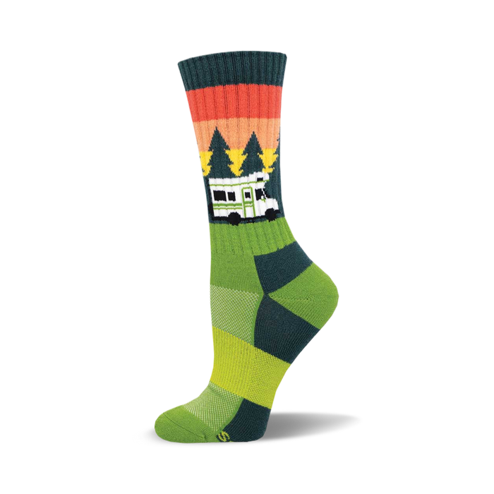 Crew socks in green, teal, and orange, featuring a retro camper van design against a sunset graphic with pine trees. }}