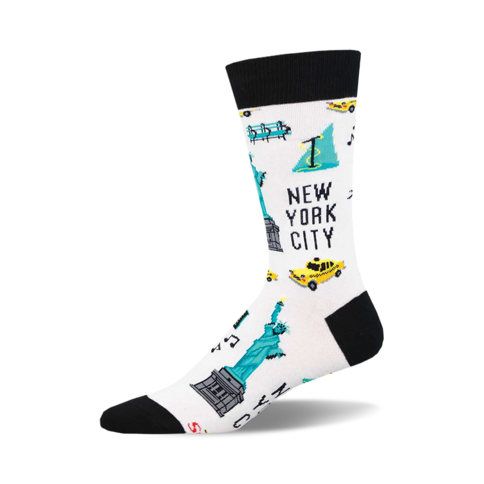 White crew socks with a black cuff, featuring pixel art of the Statue of Liberty, yellow cabs, and other NYC icons in teal and yellow. }}