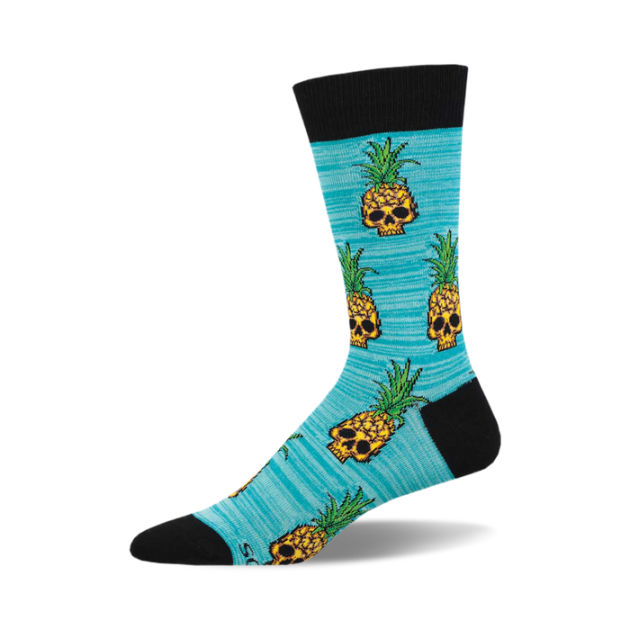 the pineapple people socks are a light blue color with an allover pattern of pixelated skulls wearing pineapple crowns. the skulls are yellow with black details, and the pineapples are green with yellow details. }}