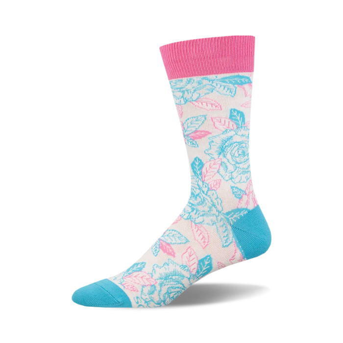 socks with a pattern of pink and blue roses on a white background. the roses have light green leaves. the top of the sock is pink. the bottom of the sock and the toe are blue. }}