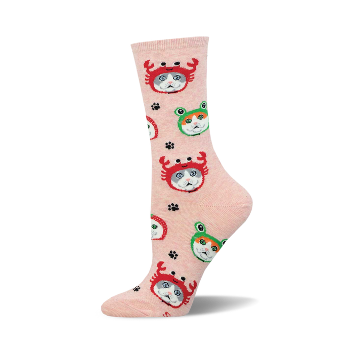 A single pink crew sock standing upright, featuring a pattern of grey and white cats wearing red crab and green frog hats.